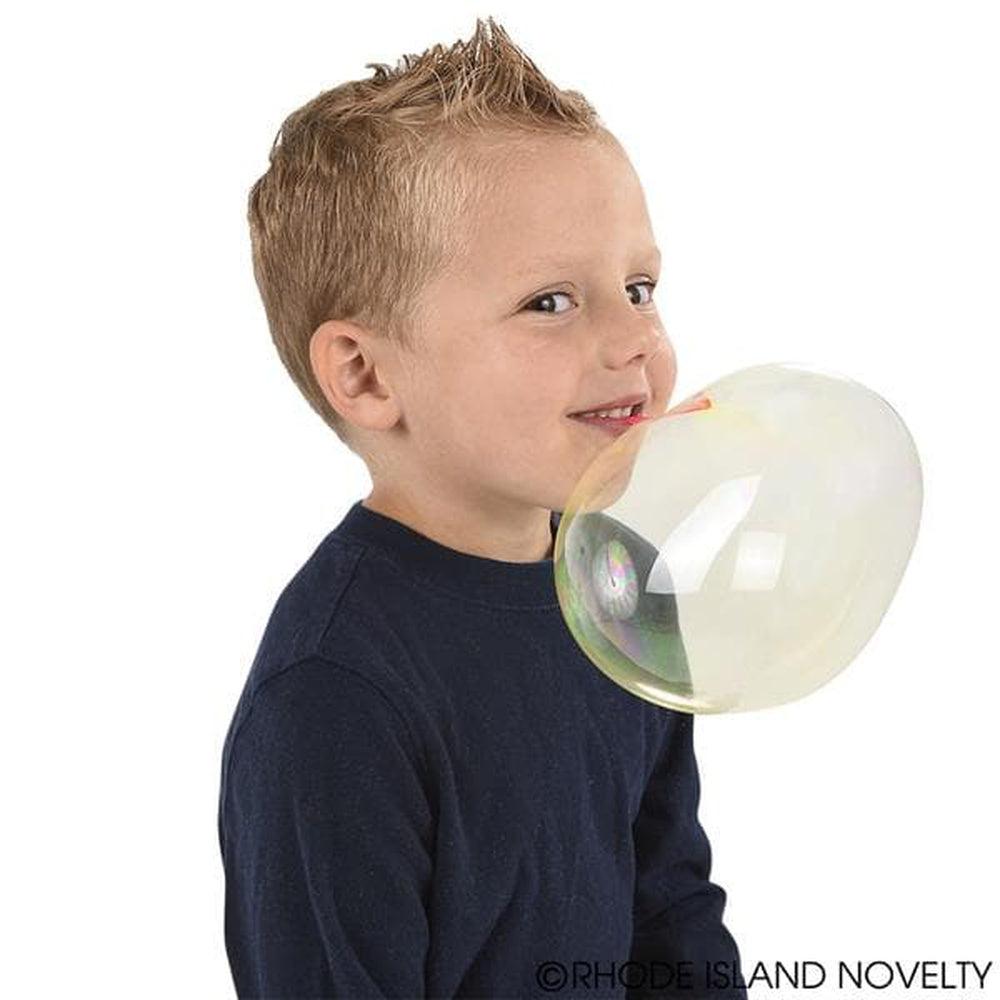 Boy blowing balloon from plastic car bottle at home stock photo